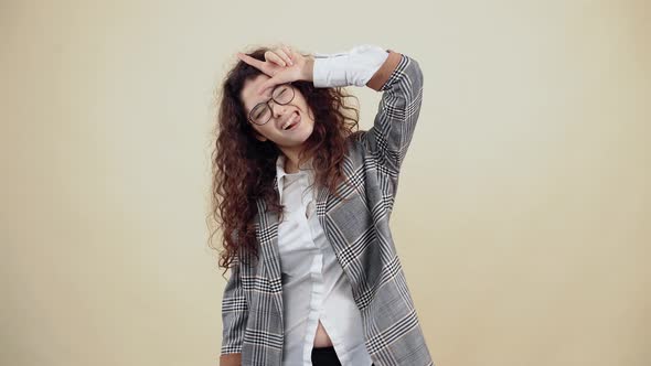 The Bored Crazy Young Woman with Her Fingers Emits Rhino Horns Fooling Around