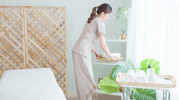 Portrait of Asian young masseuse woman smiling and looking at camera.