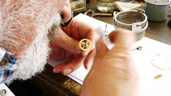 Horologist repairing a watch