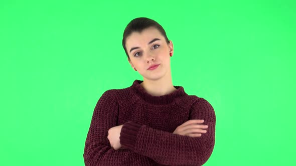 Girl Looking at the Camera with Her Arms Crossed. Green Screen