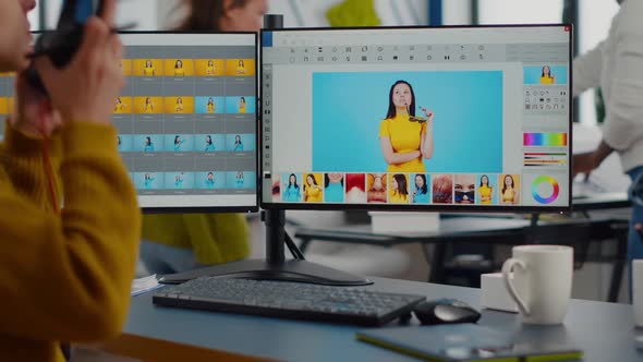 Professional Photographer Sitting at Desk Putting on Headphones