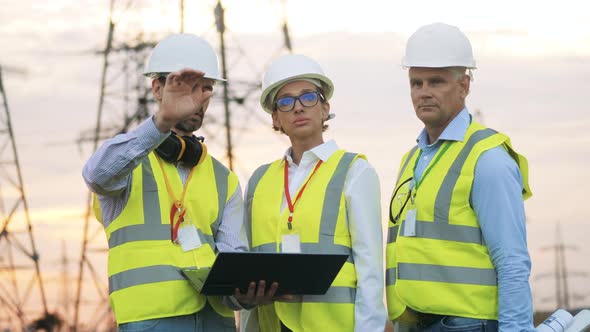 Group of Engineers Are Discussing a Powerline Project