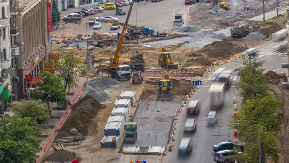 Green Vibration Roller Compactor Rolls on a Stones at Road Construction and Repairing Timelapse