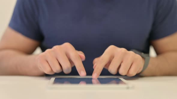 Close Up of Male Hands Typing on Tablet