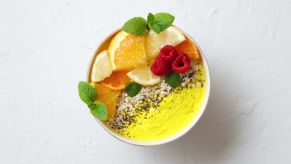 Tasty Orange Fresh Smoothie or Yogurt Served in Bowl. With Raspberries, Orange Slices, Chia Seeds