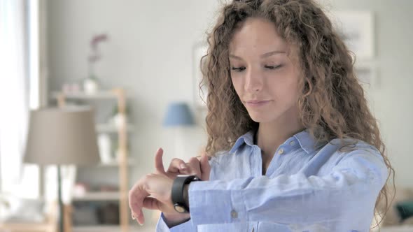 Young Curly Hair Woman Using Smartwatch