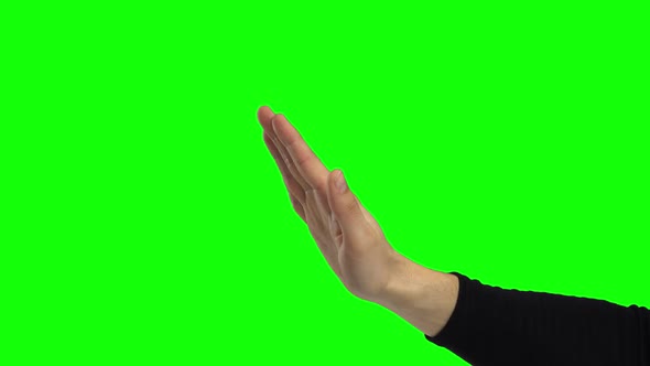 Hand of a Male Gesturing Stop. Green Screen. Close Up