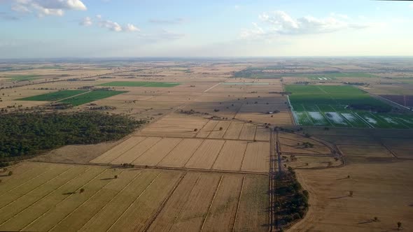 Aerial view over vast flat agricultural landscape, illustrating human beings industrial conquest ove