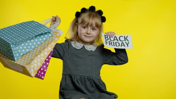 Child Girl with Shopping Bags Showing Black Friday Inscription, Satisfied with Low Prices Discounts