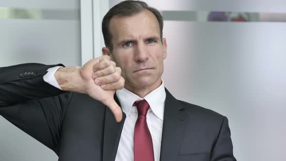 Thumbs Down by Businessman