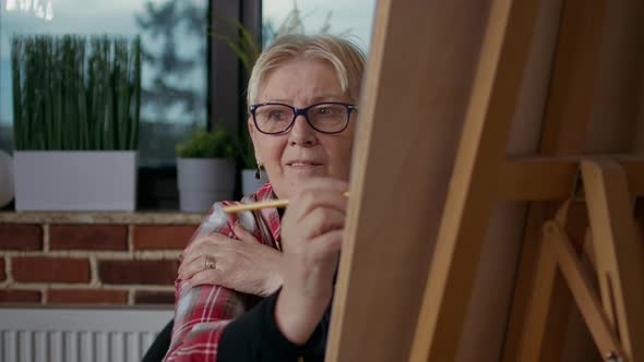 Portrait of Elder Woman Drawing Masterpiece on Canvas