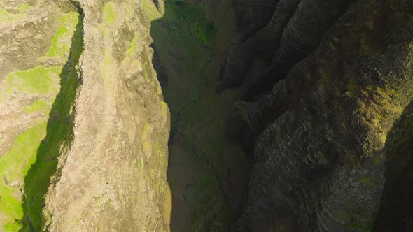 Top Down Aerial View of Deep Steep Green Canyon with Scenic Green Mountain Walls