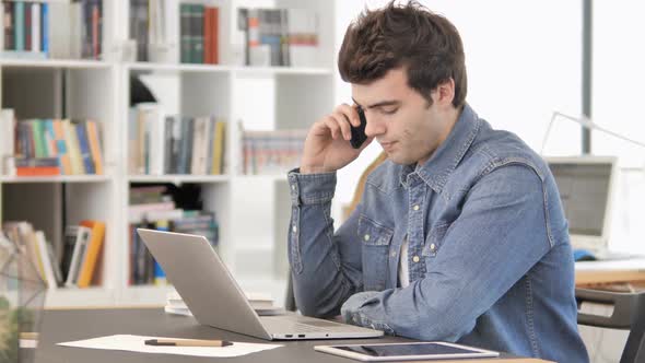 Creative Man Talking on Phone at Work