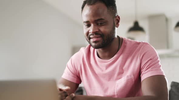 Man talking on video call by laptop