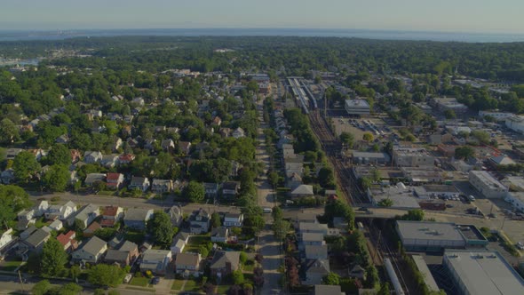 Aerial View of a Small Town in Long Island and Train Passing on Tracks