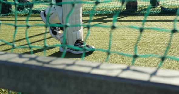 Cricket player walking on the pitch during a practice session