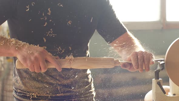 Man Carpentering in Workshop and Using Small Manual Lathe