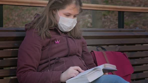 Young Girl in Black Mask Alone Outdoors. Coronavirus Pandemic