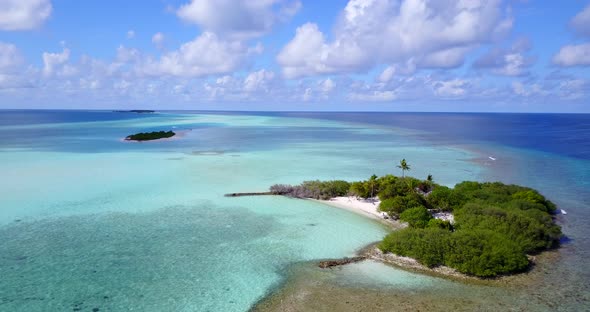 Tropical drone travel shot of a white sand paradise beach and blue sea background in hi res 4K