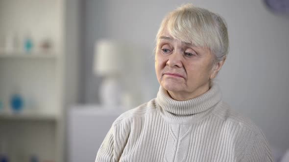 Unhappy Senior Woman in Nursing Home Feeling Depressed and Forgotten, Loneliness