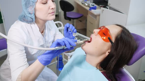 Young Woman on Preventive Examination in Dental Chair at the Dentist