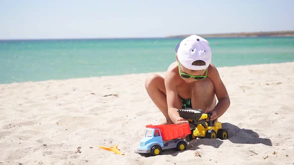 Sunny Summer Day Child Plays Toy Excavator Sandy Beach Azure Sea Blue Sky Horizon