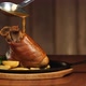 Pour the Pork Knuckle with the Sauce From the Ladle. Ready Meat Dish with Garnish in a Frying Pan - VideoHive Item for Sale