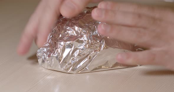 Male Cook Wraps In Food Foil A Piece Of Fresh Pork Meat