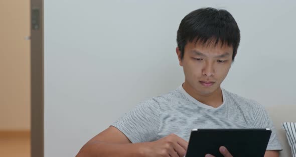 Man use of tablet computer at home