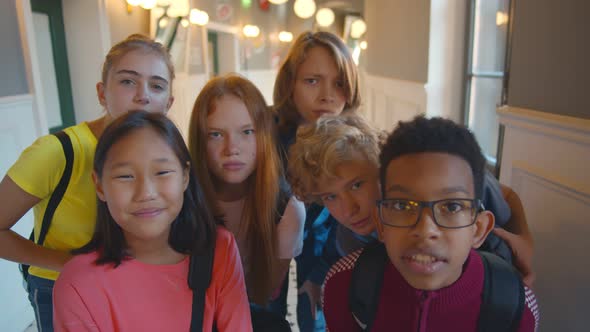 Portrait of Multiethnic Children Looking at Camera Standing in School Building