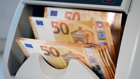 Orange Euro Banknotes Counted in a Machine.