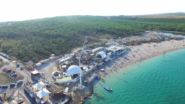 Flying above clubbing beach of Pag island in the morning