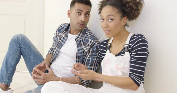 Young Black Couple Sit and Listen To Music