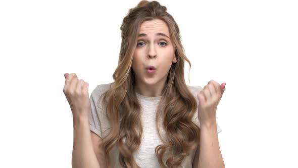 Portrait of Brunette Displeased Woman 20s in Casual Tshirt Gesturing in Furious Manner and Shouting