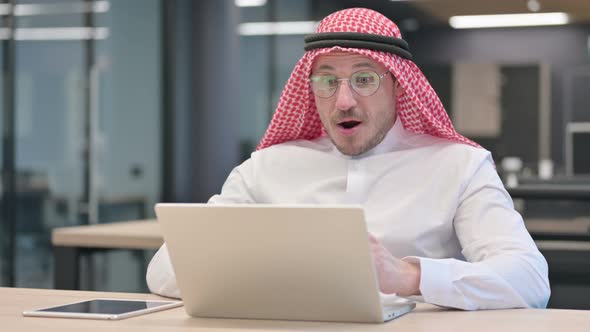 Successful Middle Aged Arab Man Celebrating on Laptop in Office