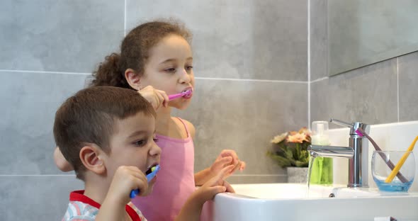 Portrait Happy Cute Young Children Brushing Teeth in Bathroom and Smiling