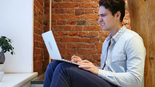 Angry Frustrated Young Man Working on Laptop