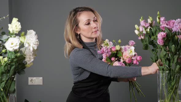 Florist Woman Composes Elegant Bouquet with Colorful Flowers