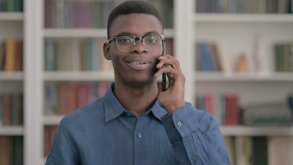 Young African Man Talking on Phone