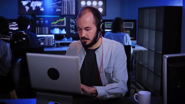 Financial Analyst Working on a Computer with MultiMonitor Workstation Stocks Commodities and