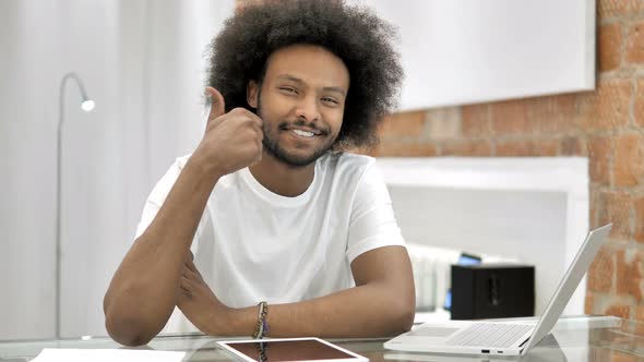 Thumbs Up By African Man Looking at Camera