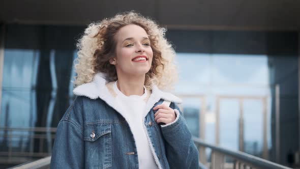 Carefree Joy and Fun. a Young Charming Girl Walks Down the Street and Smiles Broadly.