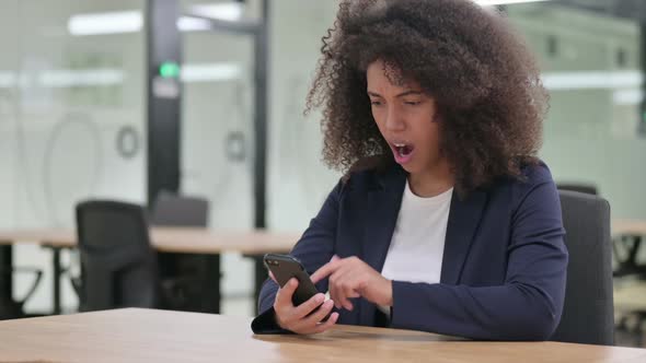 Young African Businesswoman Reacting to Loss on Smartphone
