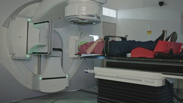 Patient Getting Radiation Therapy Treatment Inside A Modern Radiotherapy Room