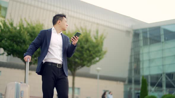 Asian business man standing on the background a modern train station airport