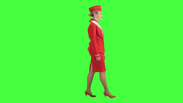 Stewardess Steps Forward and Looks in Front of Her. Green Screen. Side View