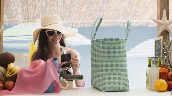 Woman searching for her phone in her full beach bag