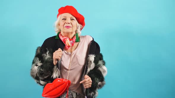 Smiling Cheerful Older Lady Dances and Looks at the Camera