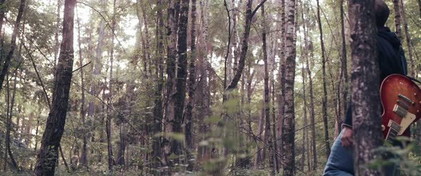 Guitar Player in the Woods