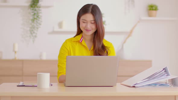 Asian Businesswoman finish work close computer laptop in workplace